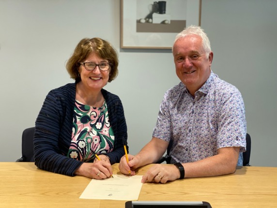 Marie Kennedy (Chairperson) and John Hanily (Board member) sign the Social Workers Registration Board Approved Qualifications Bye-Law 2022